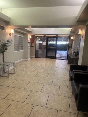 the lobby of a building with aoyer and two doors